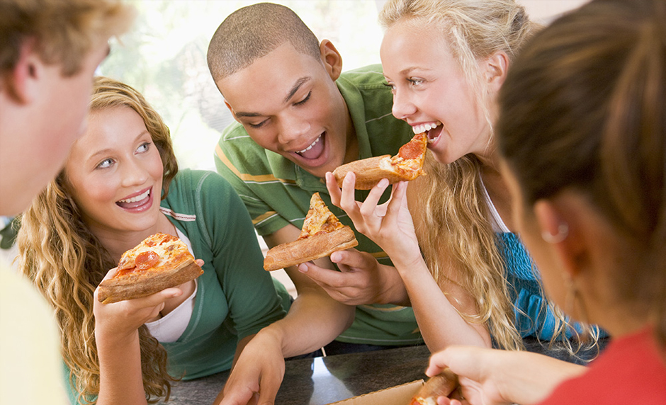 Group of Teenagers Eating Pizza